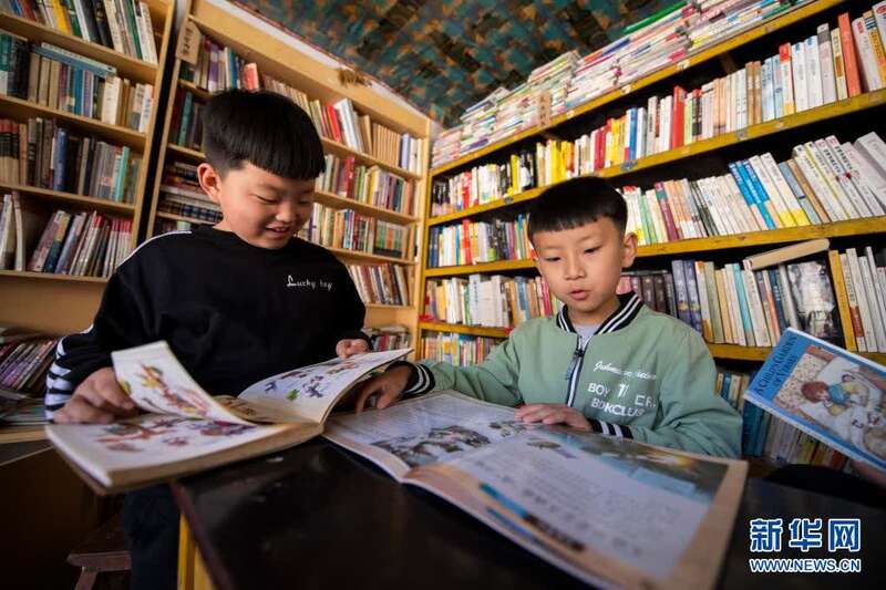 小朋友们在灵丘县东窖村大学蜂乡村图书馆内看书(4月18日摄.